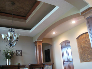 Nice dining room with new drywall and tray ceiling shown.